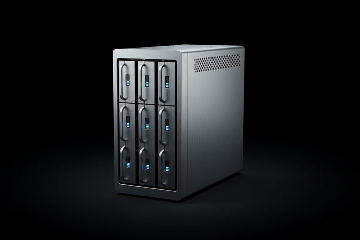 A silver 9-disk RAID storage device with six front-facing drive bays, each featuring a vertical handle and a small blue indicator light, set against a dark studio background.